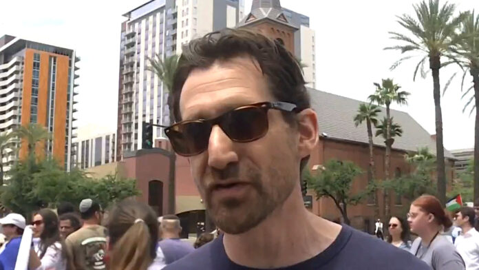 Who is ASU faculty member Jonathan Yudelman and why is he on leave from the university?